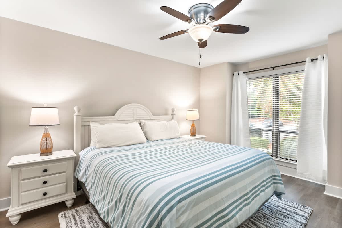 Rest peacefully in your serene bedroom with soft linens, gentle ceiling fan, and calming natural light streaming through the windows.