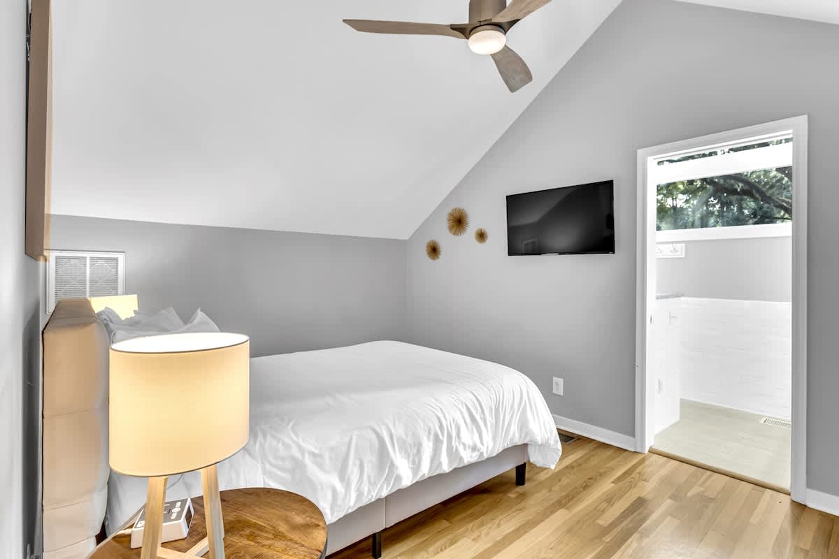 Drift off to sleep in your cozy attic bedroom, where vaulted ceilings and warm wood floors create a peaceful sanctuary.