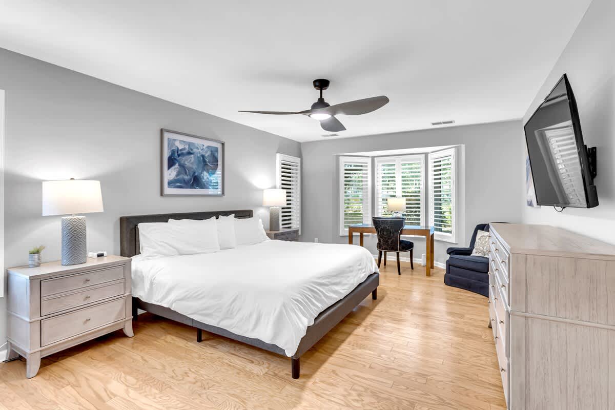 Slip into crisp linens and enjoy your modern sanctuary with hardwood floors, ceiling fan, and entertainment center for restful nights.
