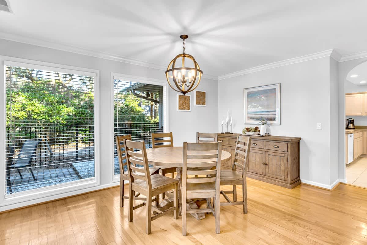 Gather around this elegant game table, where warm wood tones and beautiful natural light create the perfect setting for laughter, friendly competition, and time together.