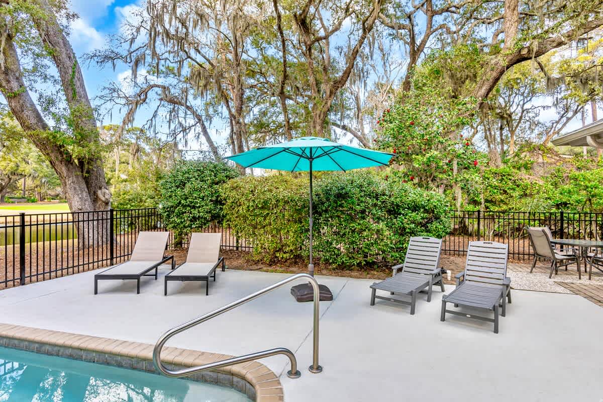 Unwind poolside under your private umbrella, surrounded by towering oaks draped in Spanish moss.