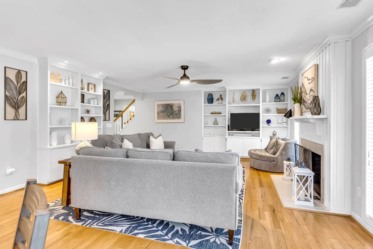 Settle into your beautifully appointed living room with custom built-ins, cozy fireplace, and thoughtful coastal touches.