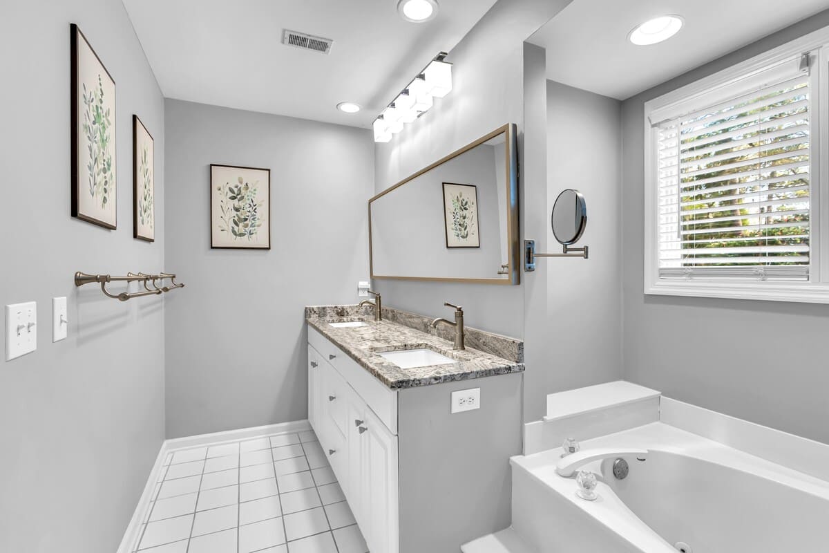 Your spa-inspired bathroom blends modern elegance with serene comfort, featuring granite counters and a soaking tub for ultimate relaxation.