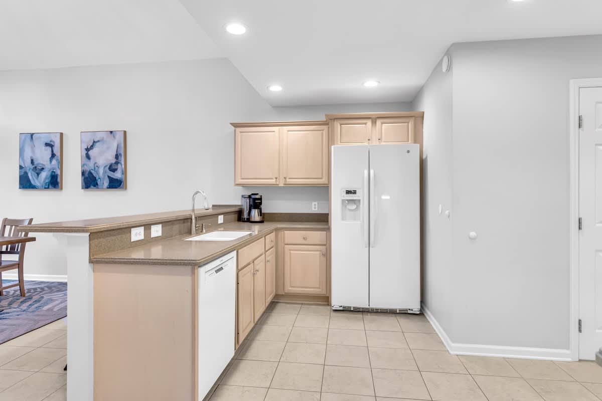 Your spacious kitchen features modern appliances, ample counter space, and sleek cabinetry—perfect for preparing meals during your stay.