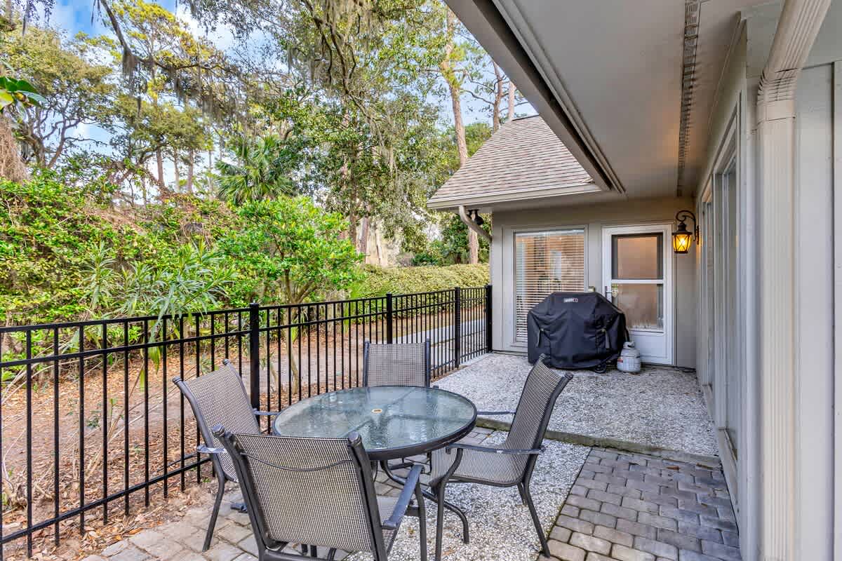 Your private patio invites relaxation with comfortable seating overlooking lush natural surroundings and your personal BBQ setup.