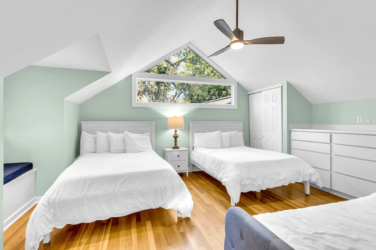 Drift off peacefully in your serene guest bedroom, where soft mint walls and crisp white linens create the perfect sanctuary for restful sleep.