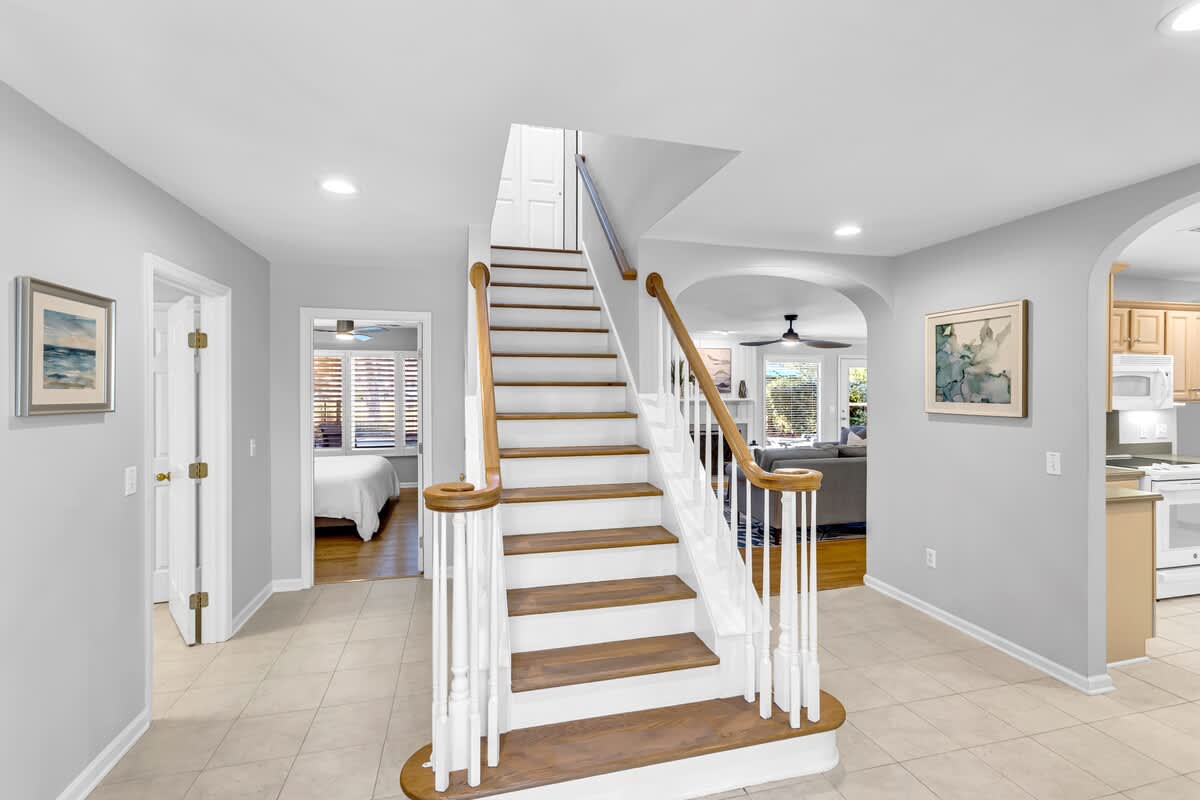 Step into your bright, open foyer where elegant stairs lead to your private retreat upstairs.