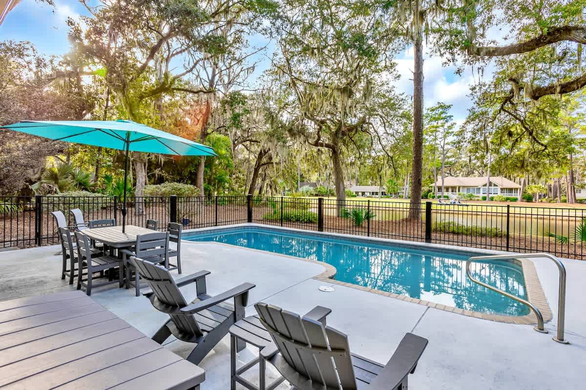 Soak up South Carolina sunshine in your private pool surrounded by majestic oak trees and Spanish moss—your perfect outdoor retreat awaits.