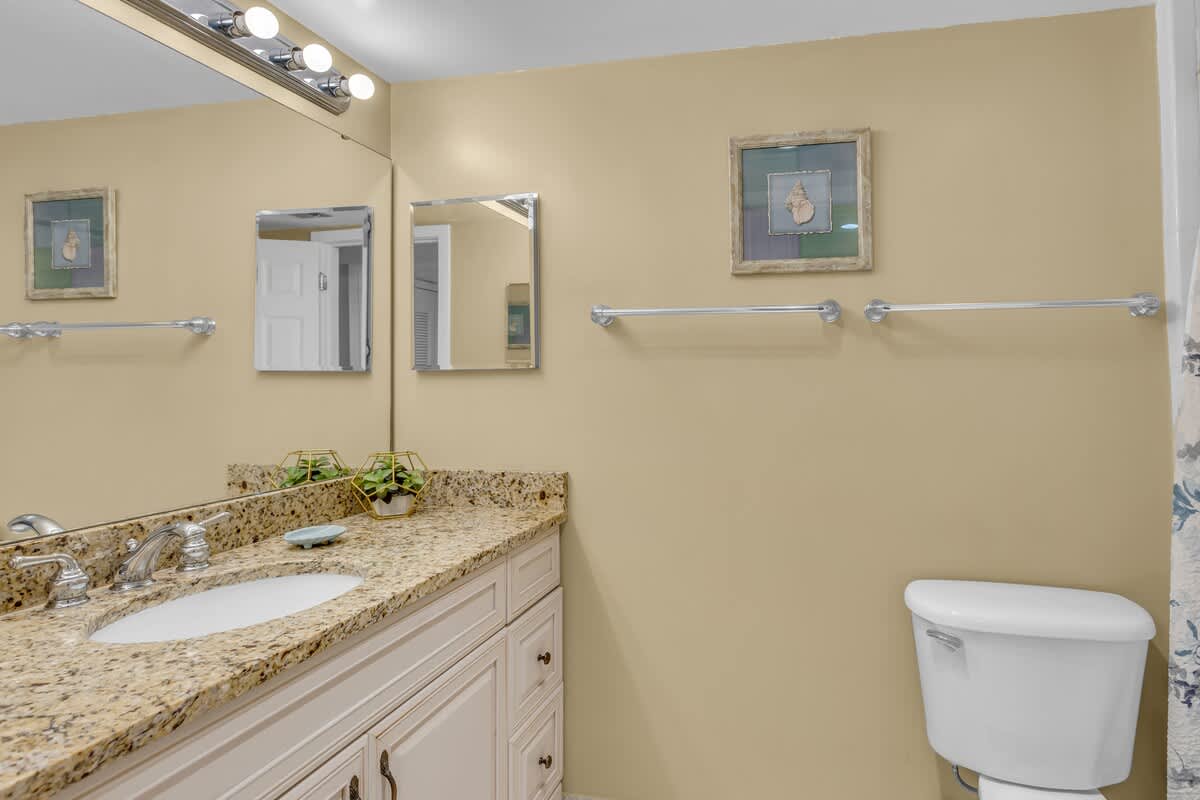 Refresh in your elegant bathroom featuring granite countertops, warm lighting, and thoughtful touches that make your daily routine feel luxurious.
