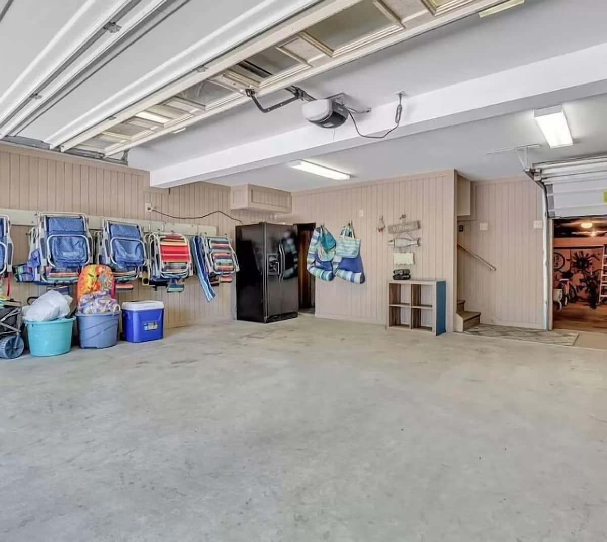 Your spacious garage offers plenty of room for beach gear storage, with chairs and coolers ready for your seaside adventures.