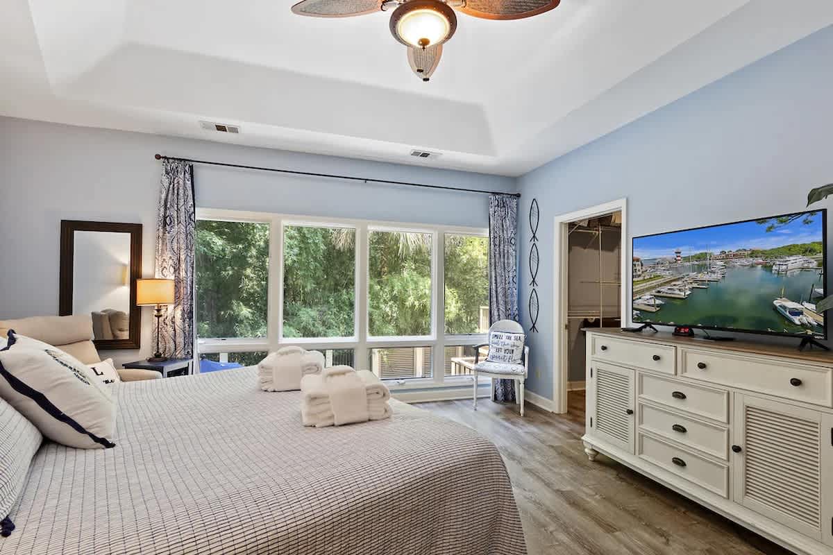 Sink into your coastal-themed master suite where soft blues and nautical touches create the perfect retreat after exploring the area.