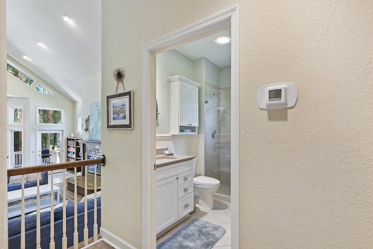 Your private bathroom features a modern shower, fresh white cabinetry, and plush soft towels for ultimate comfort.