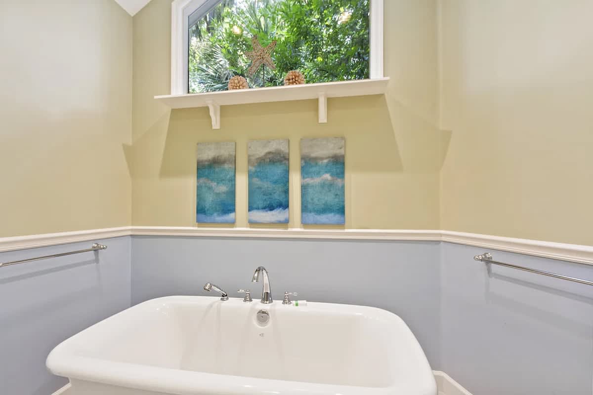 Unwind in your private soaking tub while gazing at tropical palms through the window, creating your perfect spa retreat.