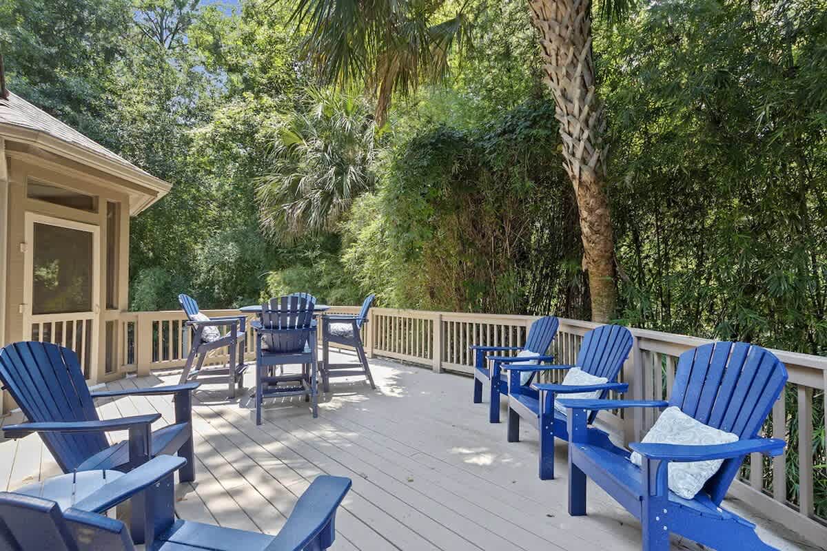 Sink into comfy Adirondack chairs on this spacious deck, where dappled sunlight filters through lush trees for perfect morning coffee moments.