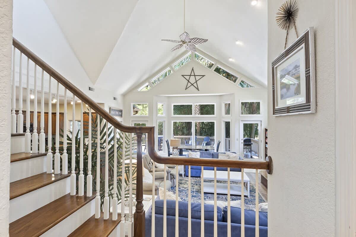 Step into your bright, airy living space where soaring ceilings and abundant windows create a perfect retreat for relaxation and connection.