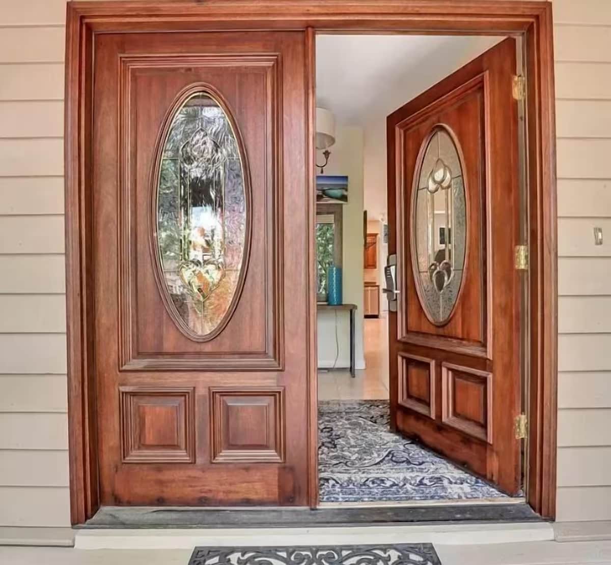 Elegant double doors with decorative glass welcome you into this beautiful home with warm wood finishes.