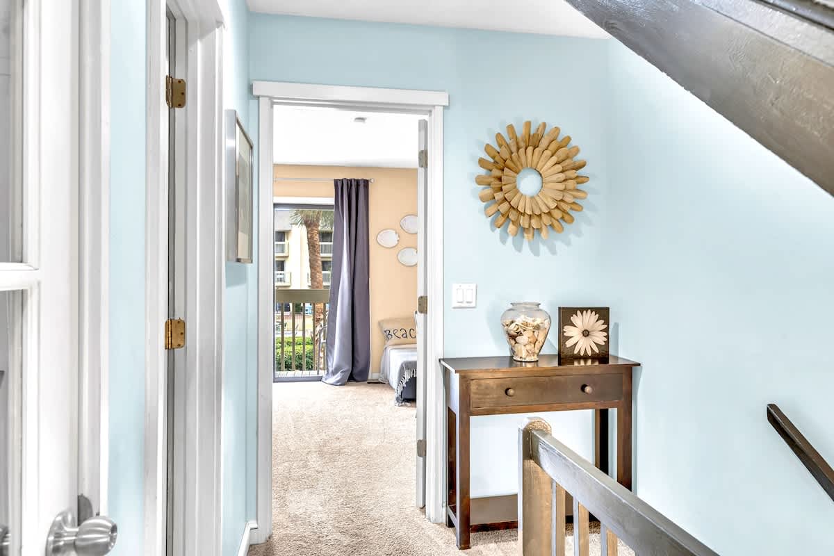 Step into your peaceful hallway where soft blue walls and warm wood accents create an instantly calming atmosphere for your getaway.