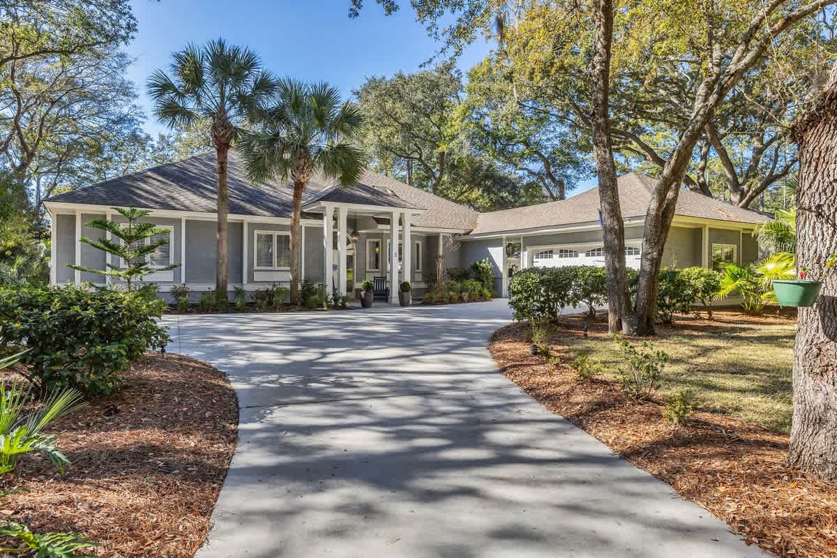 This elegant home sits beautifully among mature trees and tropical landscaping, offering a peaceful retreat in a natural setting.
