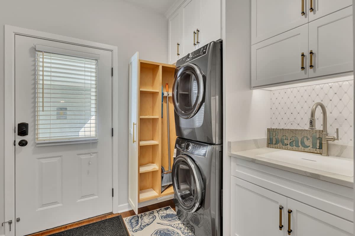 Your laundry stays fresh with these full-size washer and dryer, complete with built-in storage and a convenient utility sink.