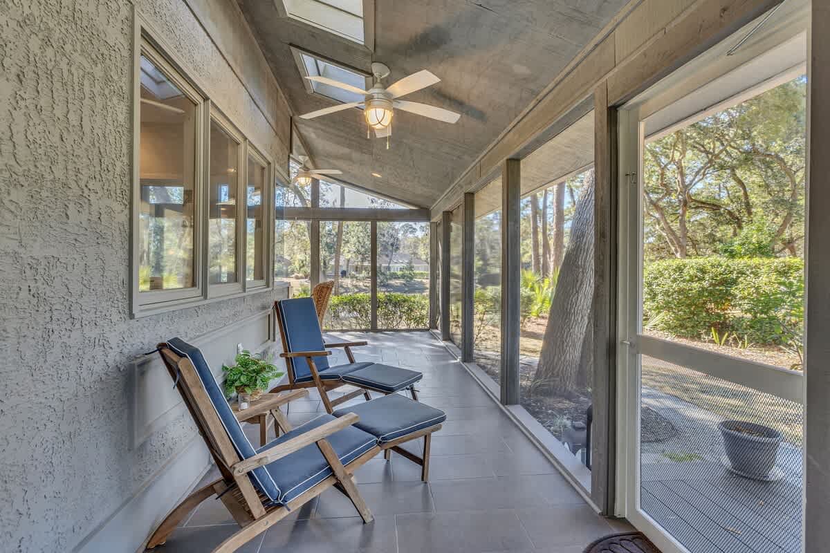 Unwind in your private screened porch with comfortable seating and peaceful garden views—perfect for morning coffee or evening relaxation.