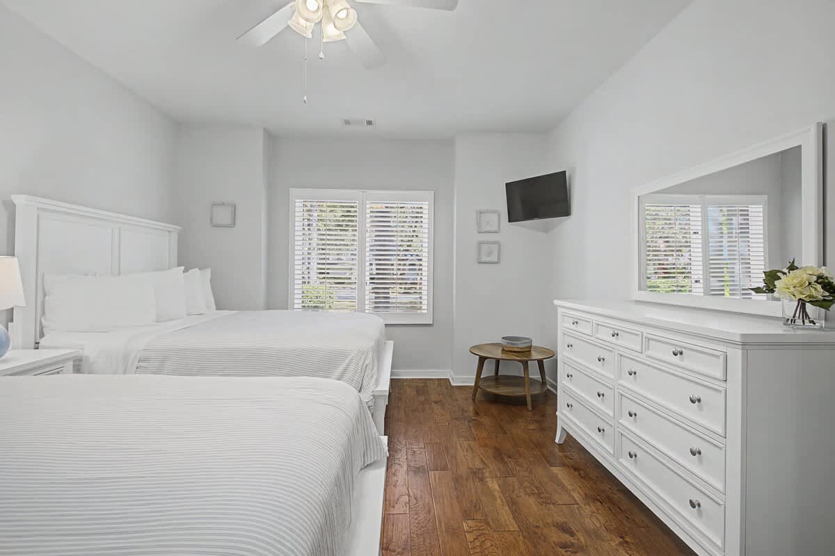 Relax in your peaceful bedroom with two comfortable beds, ample storage, and a mounted TV for your entertainment needs.