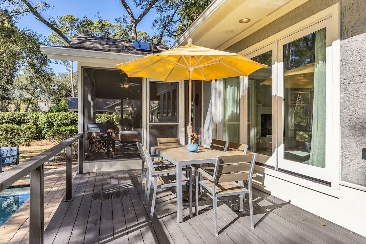 Your perfect outdoor dining awaits on this sunny deck, complete with umbrella shade and sleek furnishings for memorable al fresco meals.