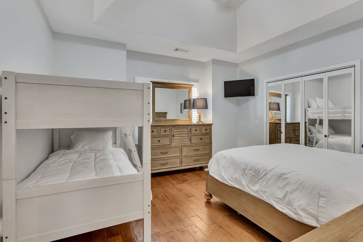 Your family bedroom features cozy bunk beds and a queen bed, perfect for creating lasting memories together in this thoughtfully designed space.