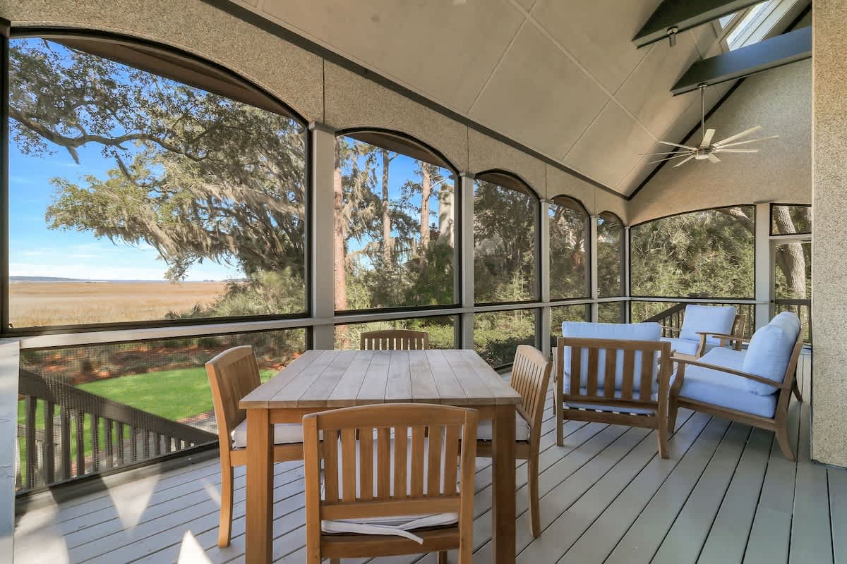 Sip your morning coffee on this screened porch while gazing across peaceful marshlands and towering oaks draped in Spanish moss.