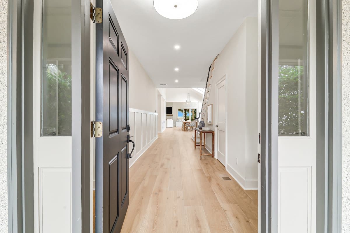 Step into your bright, welcoming hallway with gleaming hardwood floors leading to the heart of your home.