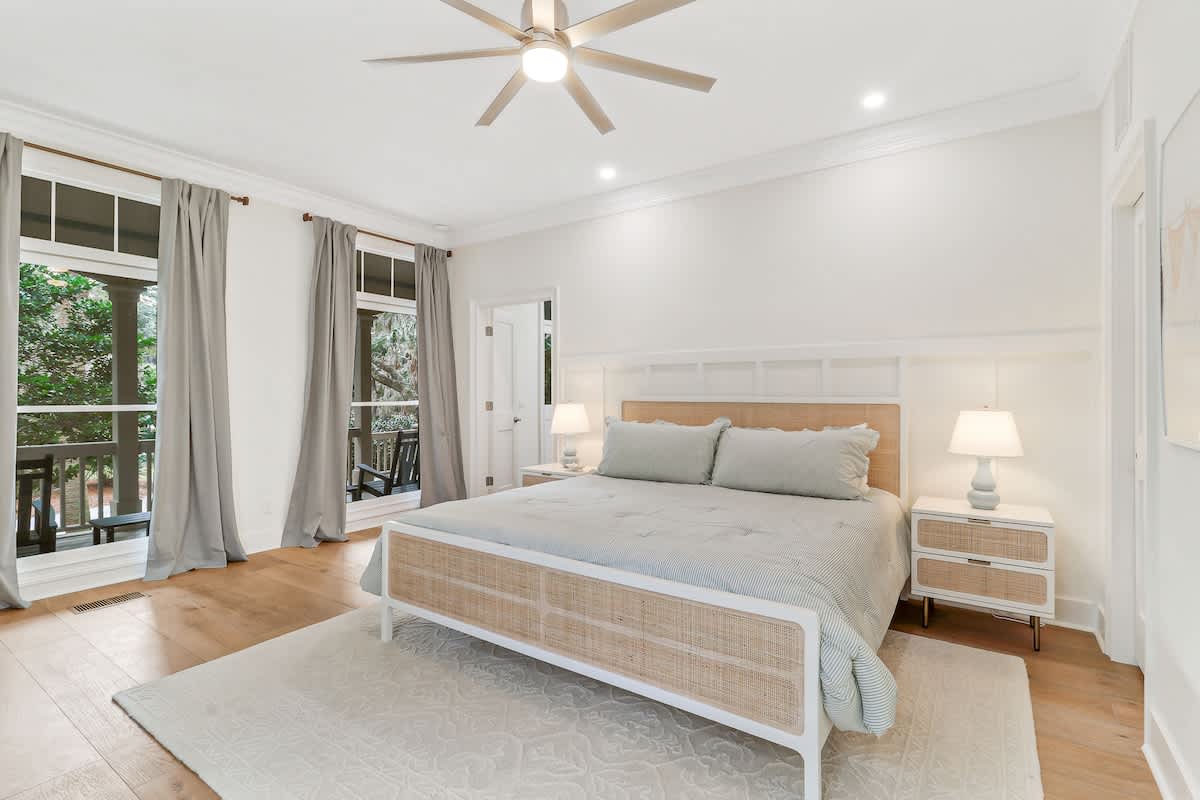 Sleep peacefully in this serene bedroom where soft linens and gentle breezes from your private balcony create the perfect retreat.