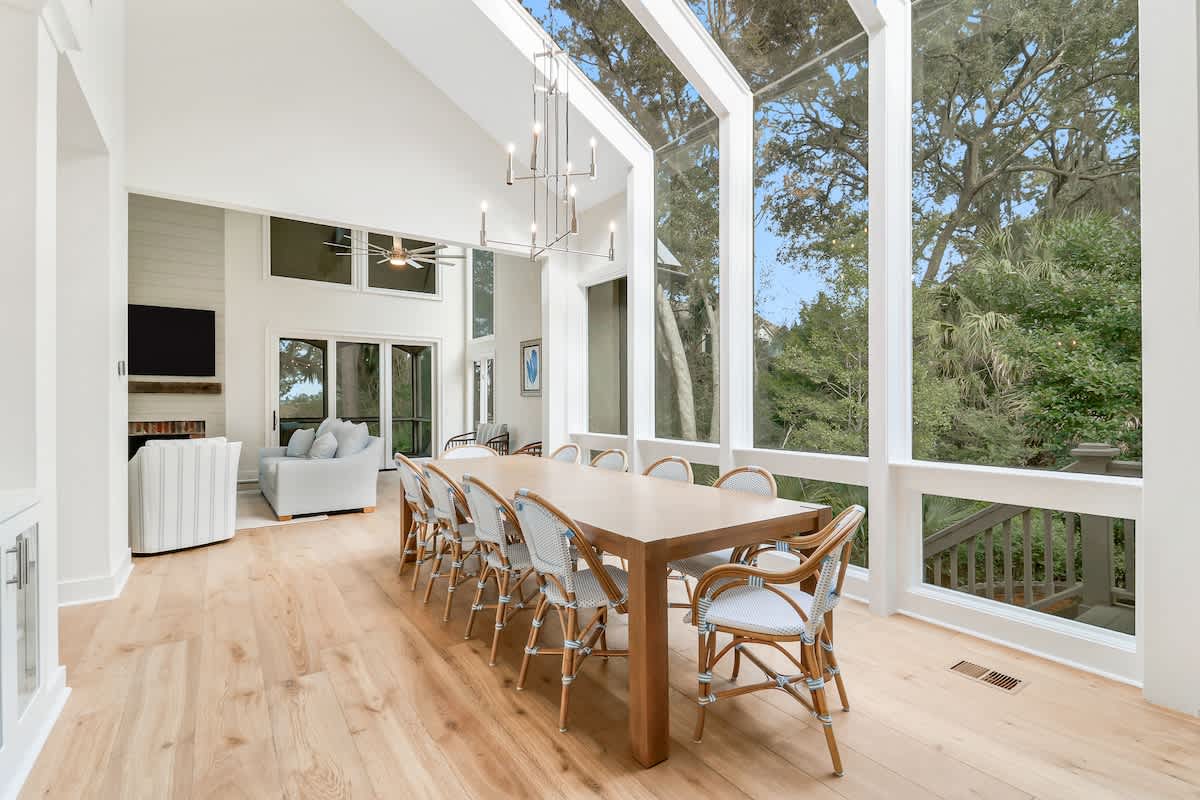 Your bright dining space flows seamlessly into the living area, perfect for memorable meals with sweeping tree views through floor-to-ceiling windows.