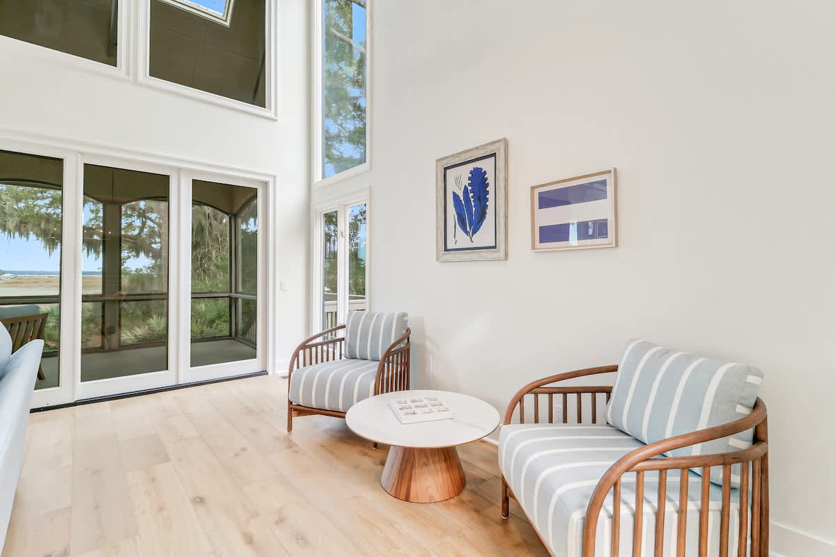 Sink into these cozy striped chairs where natural light streams through soaring windows, creating your perfect reading nook.