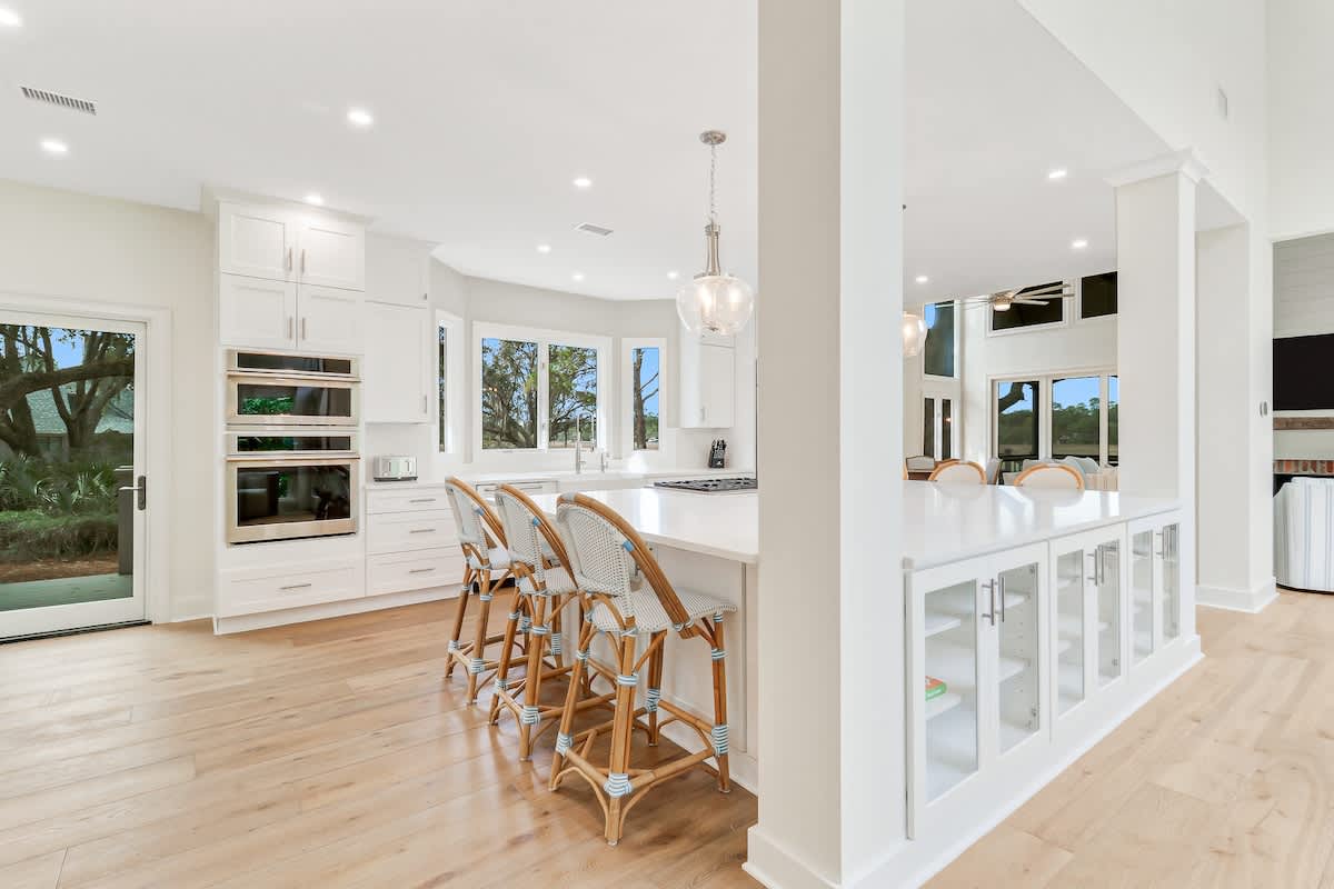 Your dream kitchen awaits with pristine white counters, stylish bar seating, and gleaming appliances where you'll create memorable meals.