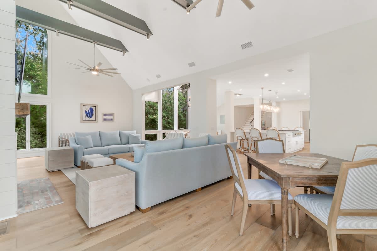 Relax in your spacious living area with soaring ceilings, modern furnishings, and abundant natural light streaming through floor-to-ceiling windows.
