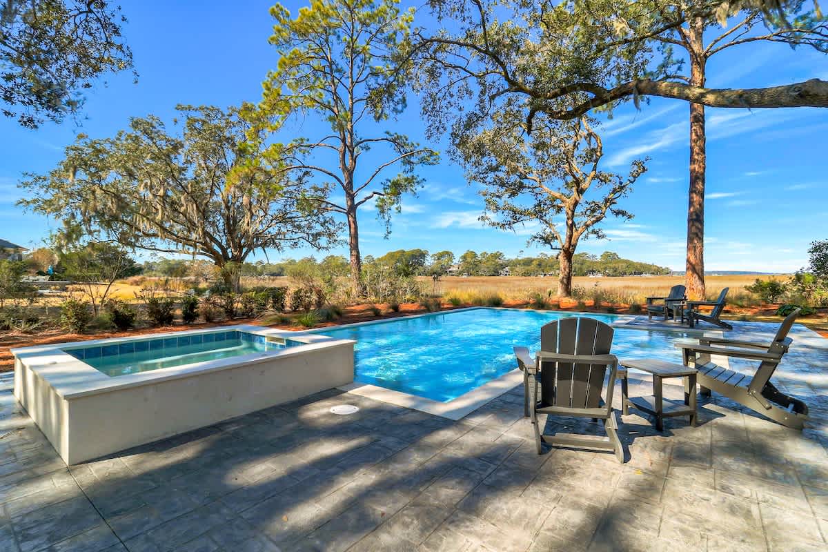 Private pool and spa surrounded by native trees and rolling landscape views.