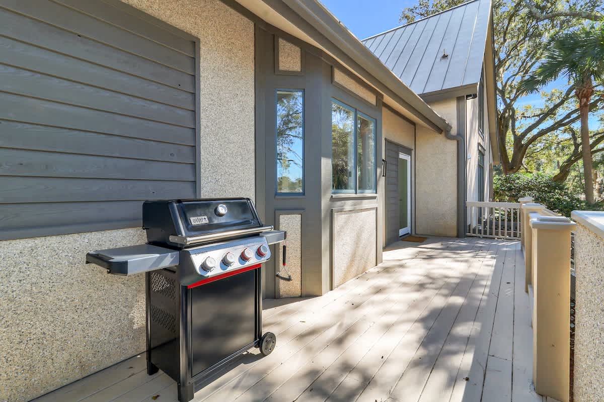 Step onto your private deck where a premium Weber grill awaits your outdoor cooking adventures under swaying palms.