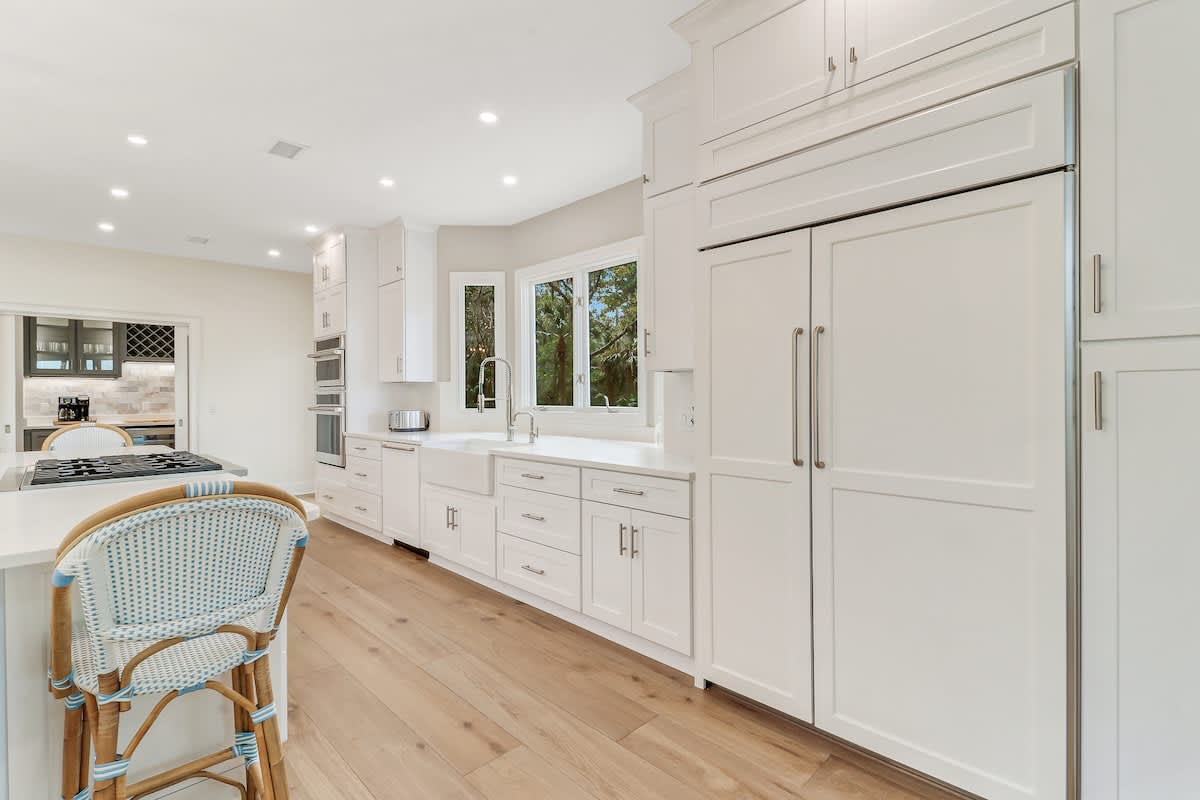 Cook with ease in this bright, modern kitchen featuring premium appliances and elegant white cabinetry.