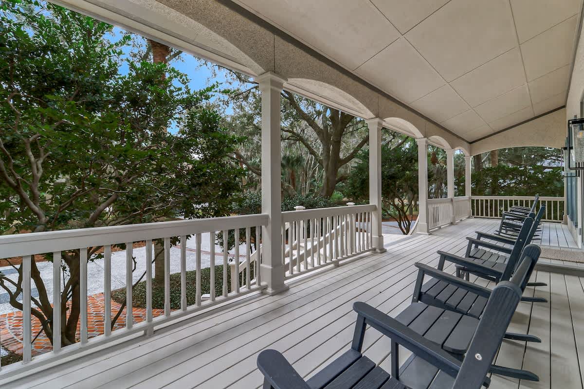 Relax in your private rocking chairs on this spacious covered porch, surrounded by lush tropical greenery and gentle shade.
