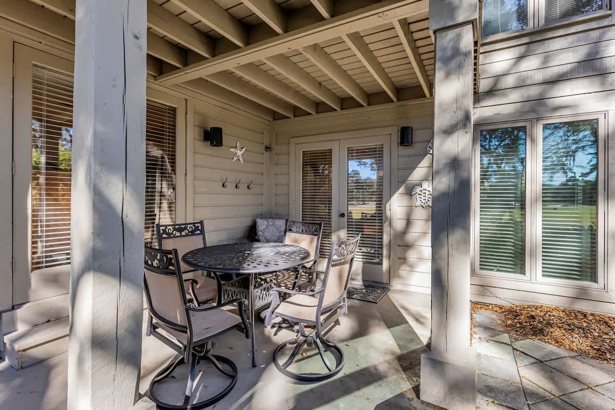 Your private covered patio awaits with comfortable outdoor dining and coastal touches—perfect for morning coffee or sunset meals.