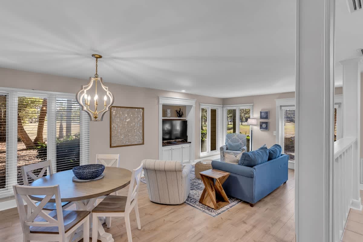 Unwind in your bright, open-concept living space where coastal blues meet modern comfort, perfect for relaxing after sunny adventures.