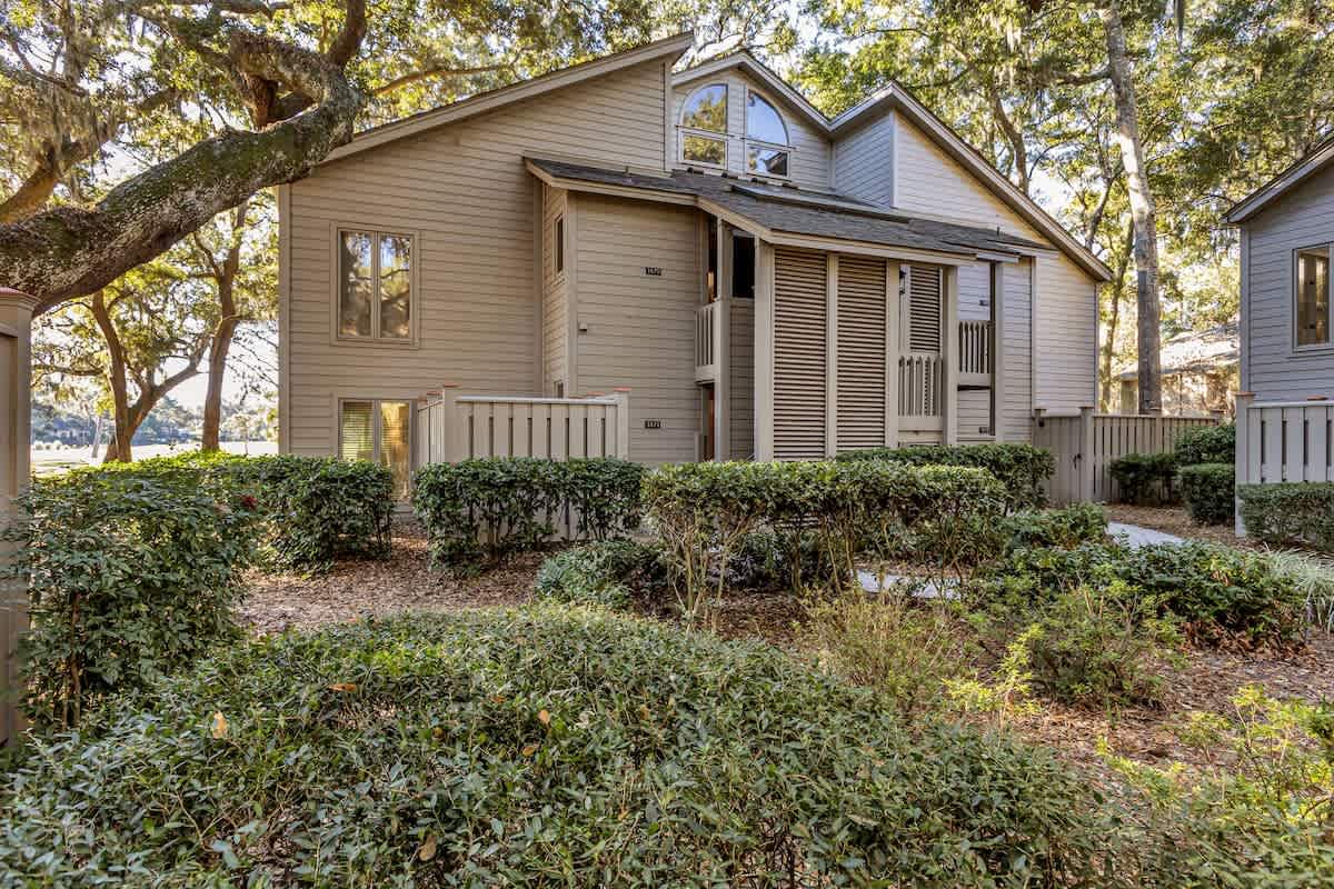 This charming property sits nestled among mature oak trees with natural landscaping creating a peaceful retreat setting.