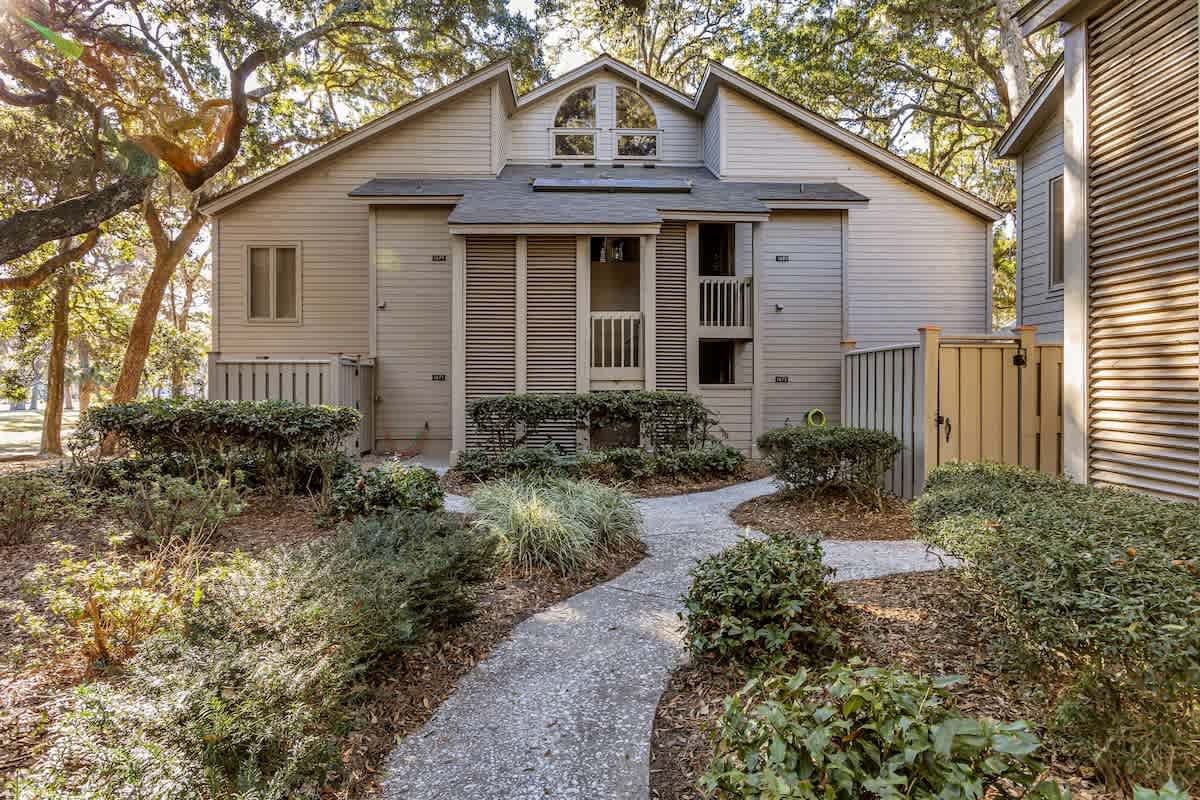 Charming vacation townhome nestled among mature trees with private entrance and landscaped gardens welcoming your arrival.