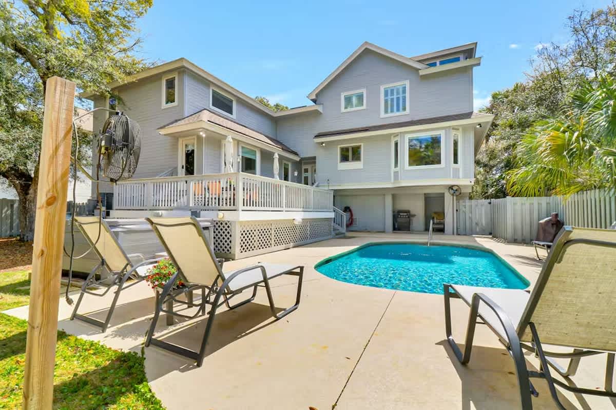 Dive into your private oasis with crystal-clear pool waters surrounded by comfortable loungers and tropical palms.