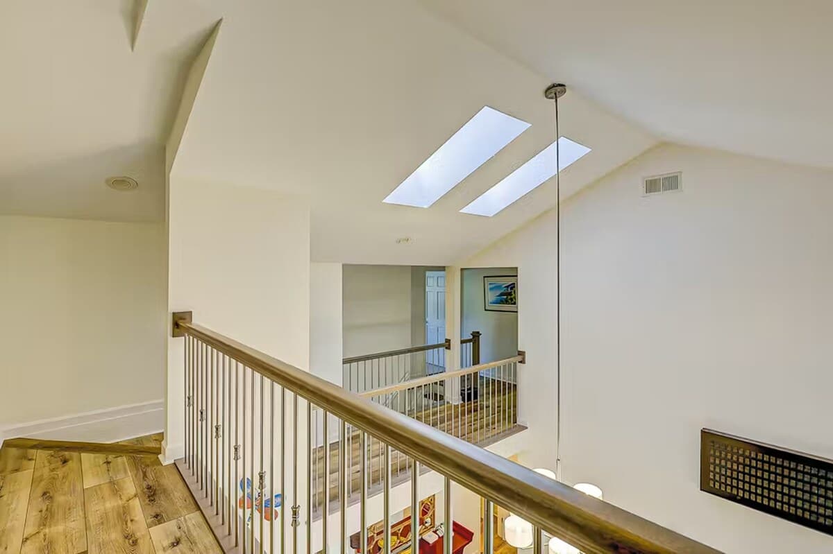 Natural light floods through skylights in this airy upstairs landing, creating a bright, welcoming space as you move between floors.