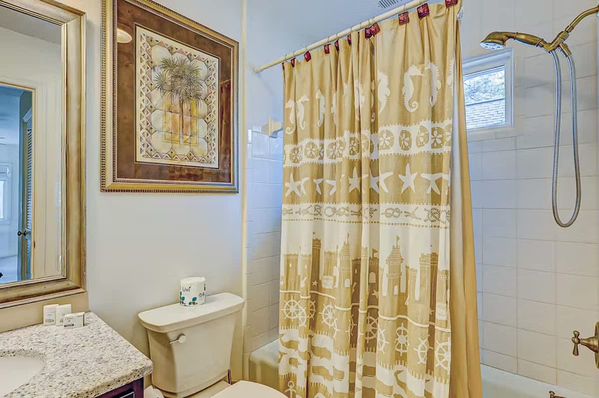 Refresh in your private bathroom with coastal charm, featuring a spacious shower and nautical touches that make every morning feel like a seaside getaway.