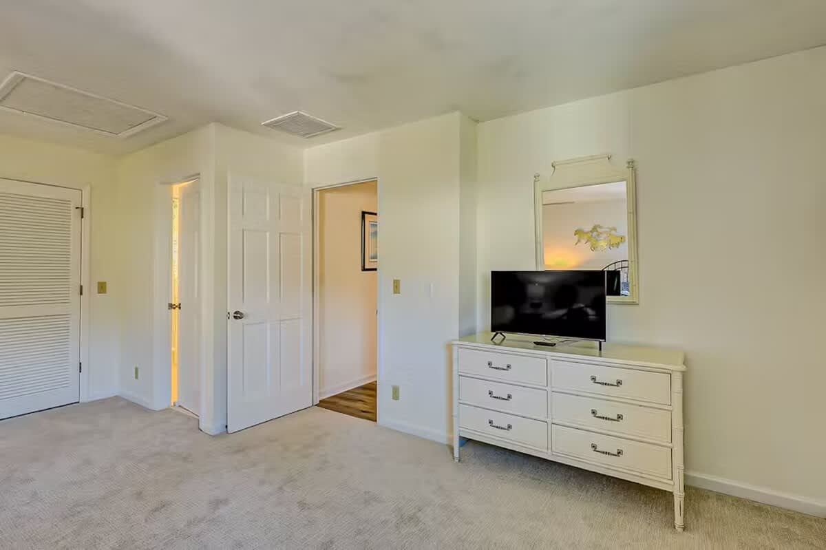 Your bedroom features a spacious dresser with flat-screen TV and ample storage for all your belongings during your stay.