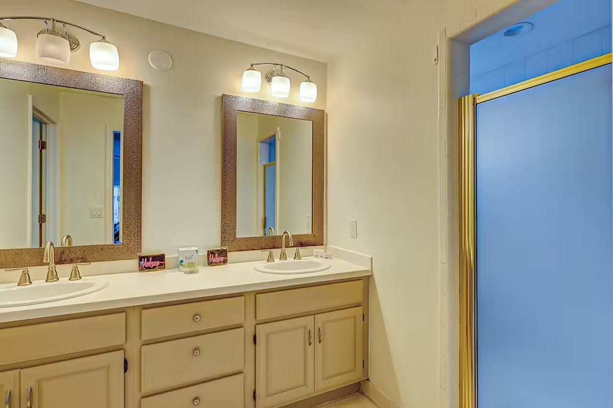 Your spacious bathroom features dual vanities with elegant lighting, providing ample space to prepare for your day in comfort.