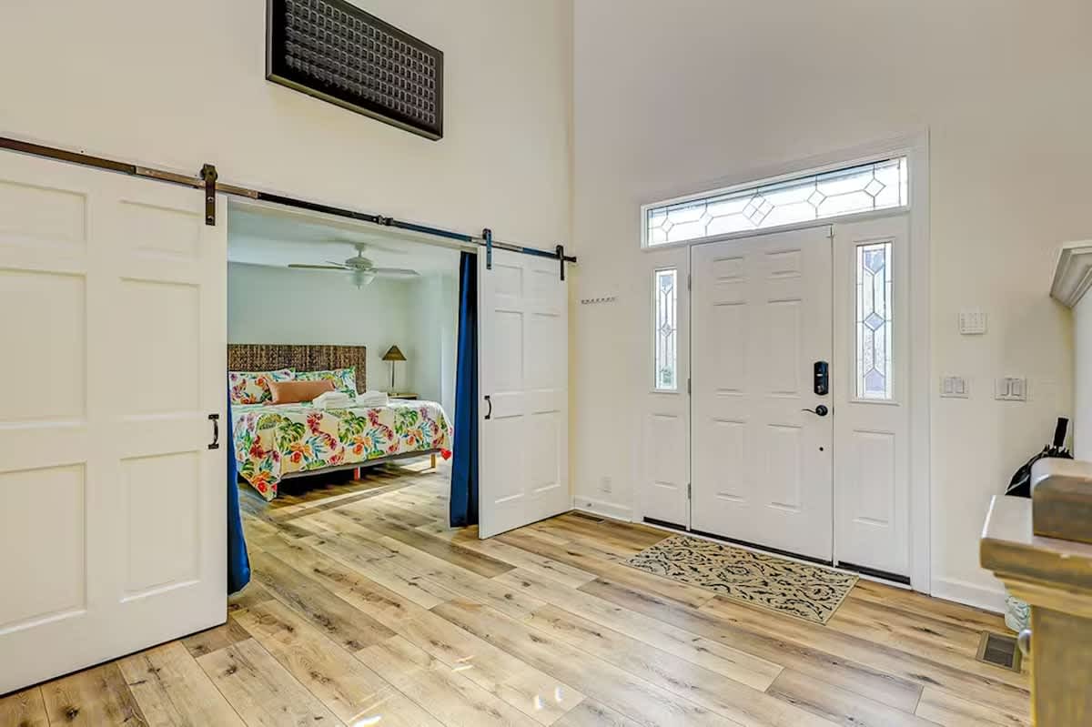 Step into your stylish retreat where rustic barn doors slide to reveal your cozy bedroom sanctuary, complete with beautiful hardwood floors throughout.