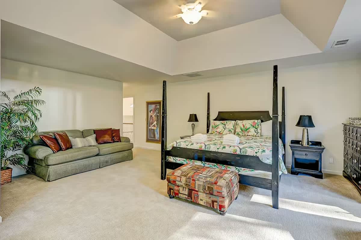 Your spacious suite combines comfort with style, featuring a stunning four-poster bed and cozy seating area for ultimate relaxation.