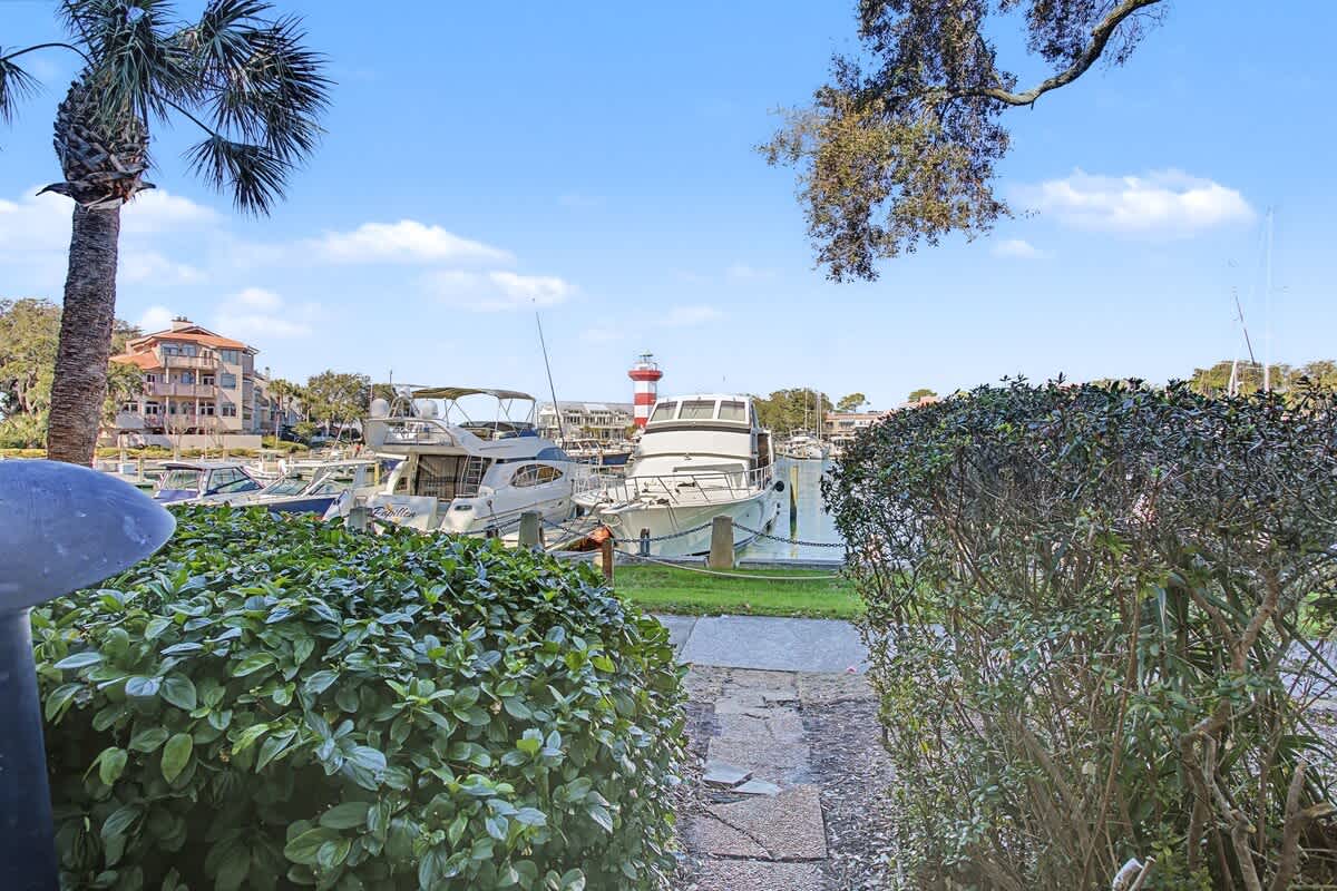 Scenic marina pathway with boats and palm trees in the charming coastal neighborhood surrounding the property.